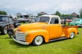 Modified yellow Chevrolet 3100 truck displayed on outdoor car show Royalty Free Stock Photo