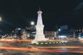 Yogyakarta, Indonesia - November, 2019: Tugu Jogja or Yogyakarta Monument, Indonesia. Taken in night with vehicle traffic light. Royalty Free Stock Photo