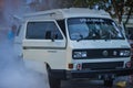 Volkswagen T3 camper on fire and extinguished by people