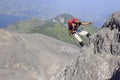 A climber descends lava rock on the peak wall of Merapi