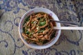 Large portions of Mie Ayam, and chicken claw topping fill the bowl