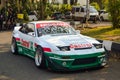 Modified Nissan 200SX S13 on parking lot during afternoon