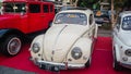 White Volkswagen Beetle on display at outdoor car meet Royalty Free Stock Photo