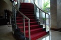 Classic staircase with curved design and red carpet