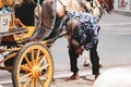 Yogyakarta in October 2022. A wagon rider is changing a horseshoe from his horse Royalty Free Stock Photo