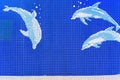 Background of a blue mosaic depicting dolphins diving underwater.