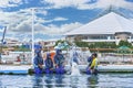 Laughing young people sprinkling on water by a Beluga whale at Hakkeijima Sea Paradise. Royalty Free Stock Photo