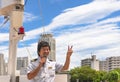 Smiling man in Ship Captain Uniform making a peace sign during the yokosuka military port tour. Royalty Free Stock Photo