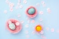 Yolk of broken egg in eggshell and two blue eggs decorated with Royalty Free Stock Photo