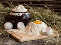 Yolk in flour. Broken egg. White egg. Flour in a clay pot. Royalty Free Stock Photo
