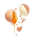 Yolk is pouring out from a chicken egg broken into two halves Royalty Free Stock Photo