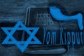 Yom Kippur Day of Atonement, concept. In the foreground: Magen David Jewish star, title Yom Kippur and Shofar RamÃ¢â¬â¢s Horn