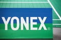 Yonex logo around a badminton court