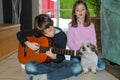 Boy practicing playing guitar, his sister sings Royalty Free Stock Photo