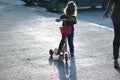 Yong kid girl ride on street with child scooter