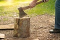 yong male in forest choping wood with steel axe Royalty Free Stock Photo