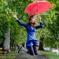 Yong woman jump with red umbrella