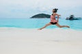 Yong woman jumping on a beach