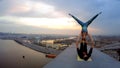 Yong woman and man doing extreme stunts on top of bridge, fantastic city view Royalty Free Stock Photo