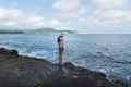 Young beatiful tourist woman looking into the sea at Yongmeori Beach, Sanbang-ro, Jeju Island, South Korea
