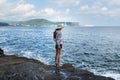 Young beautiful tourist lady looking thoughtful at Yongmeori Beach, Sanbang-ro, Jeju Island, South Korea