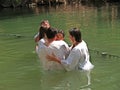 YORDANIT, ISRAEL. Pilgrims make ablution in holy waters of the Jordan River