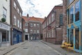 Old brick buildings housing shops and restaurants on alley of Back Swinegate in historic district of City of York, England, UK