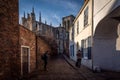 YORK, ENGLAND, DECEMBER 13, 2018: People taking photographs in a cobbled brick street that leads to the magnificent York