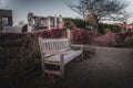 YORK, ENGLAND, DECEMBER 12, 2018: Wooden bench in an old park full of dry leaves. Concept of tranquility and peaceful Royalty Free Stock Photo