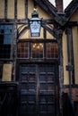 YORK, ENGLAND, DECEMBER 12, 2018: Yorkshire`s Merchant Adventurers Hall wooden doorstep and old lantern with its logo