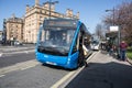 Blue York and Country branded bus at a bus stop picking up passengers in sunshine. Public transport in urban environment. Optare