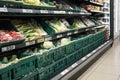 Grocery store aisle showing vegetables on display