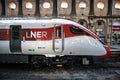 LNER Azuma train on a platform inside historic old train station