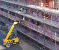 Building workers in protective clothing on scaffolding on a residential constriction site in the center of york