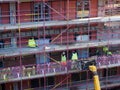 Building workers in protective clothing on scaffolding on a residential constriction site in the center of york