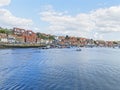 A small boat sails on the rippled waters of Whitby harbour