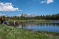 Yosemite National Park, CA - Family fishes in a small pond in Yosemite National Park, off of Tioga Pass on a sunny