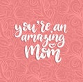 You Are An Amazing Mom vector calligraphy. Happy Mothers Day hand lettering illustration on abstract background.