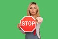 You are banned, no access, prohibited to go! Portrait of serious bossy adult woman holding octagonal red Stop traffic sign Royalty Free Stock Photo