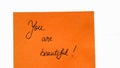 You are beautiful handwriting text close up isolated on orange paper with copy space Royalty Free Stock Photo