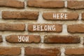 You belong here and support symbol. Concept words You belong here on brick wall. Beautiful brick wall background. Psychological