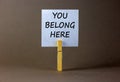 You belong here symbol. Words \'you belong here\'. Beautiful grey background.