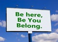 You belong here symbol. Words `be here, be you, belong` on white billboard. Beautiful blue sky. Business, diversity, inclusion, Royalty Free Stock Photo