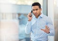 You better not be saying this. a young businessman looking angry while making a phone call using his smartphone. Royalty Free Stock Photo