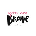 You are brave. Inspirational quote, brush calligraphy. Pink and black handwritten text on white. Royalty Free Stock Photo