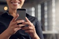 You can do anything with a touch of a button...a young businesswoman using her cellphone at the office. Royalty Free Stock Photo