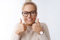 You can do it, believe. Portrait of optimistic friendly-looking excited cheerful young blond woman in glasses showing