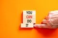 You can do it symbol. Concept word You can do it on beautiful wooden block. Beautiful orange table orange background. Businessman Royalty Free Stock Photo