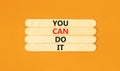 You can do it symbol. Concept word You can do it on beautiful wooden stick. Beautiful orange table orange background. Business Royalty Free Stock Photo