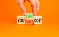 You can do it symbol. Concept word You can or can not do it on beautiful wooden cubes. Beautiful orange table orange background. Royalty Free Stock Photo